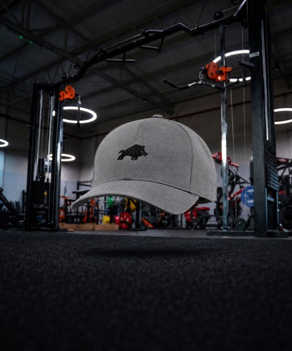 Generated with Kive.ai - Create a premium cinematic product photo of product using Gym as the exact unchanged background. Place the cap levitating in the empty foreground_ exactly in the horizontal center of .jpg